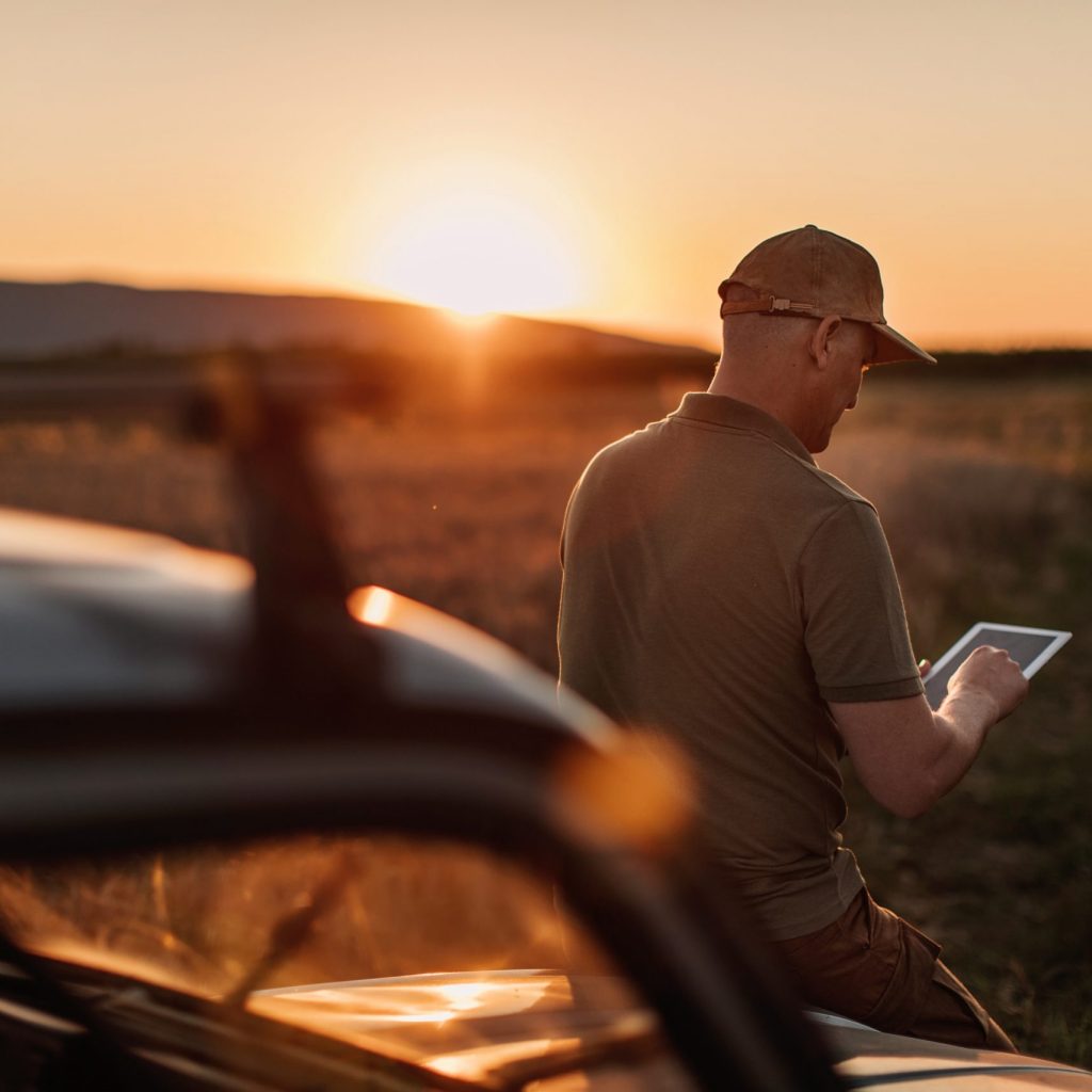 Broadband Rental in Alberta Mid adult farmer inspects his land