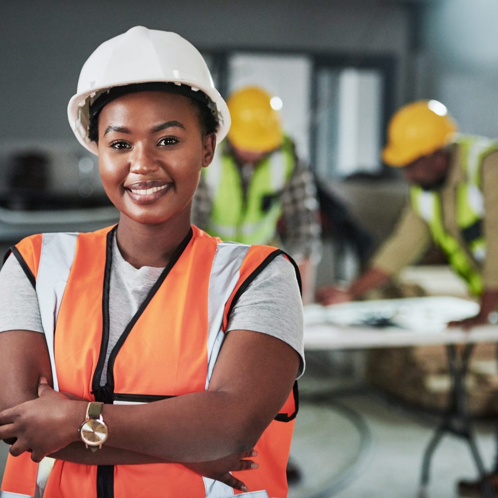 Construction Project Management in Alberta Telecom project manager in safety gear leading telecommunication engineering team onsite.
