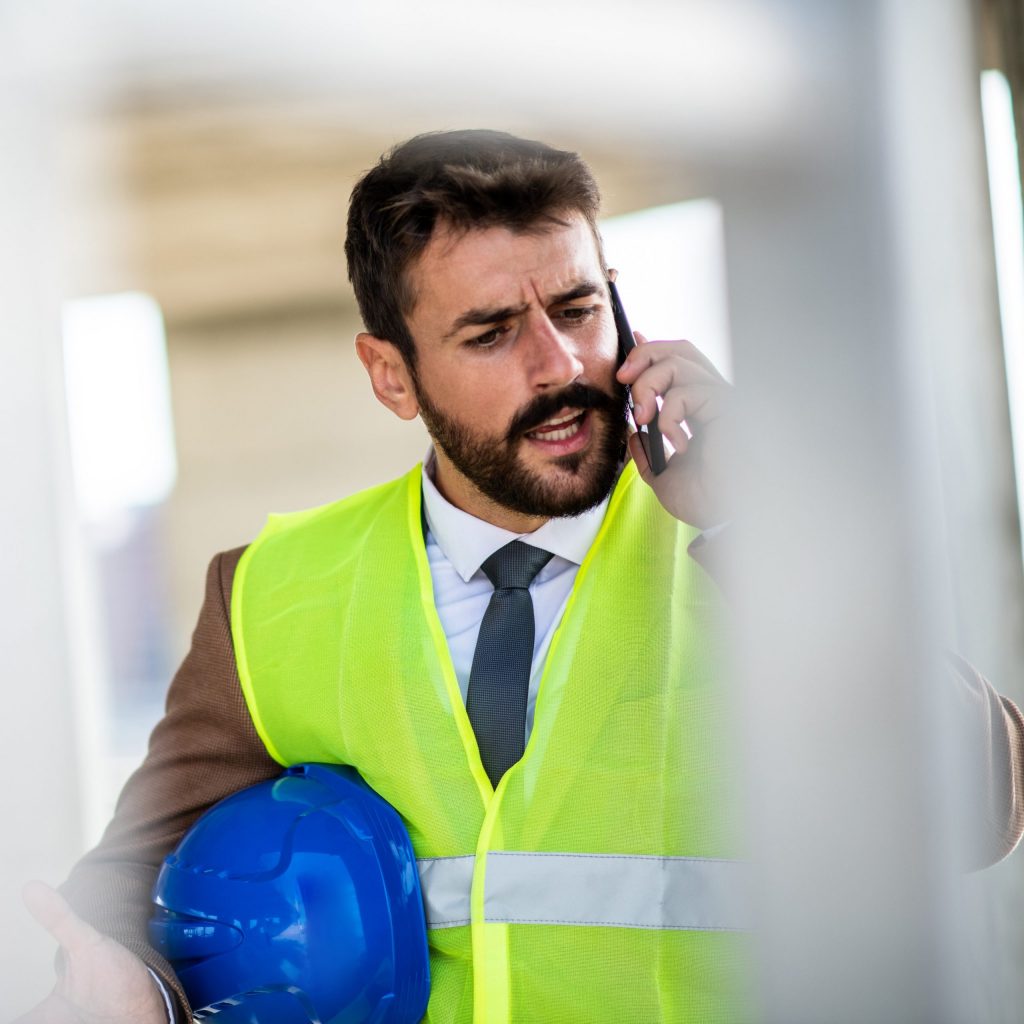 A construction engineer is speaking with his colleague on the phone about problems at the construction site and possible solutions.