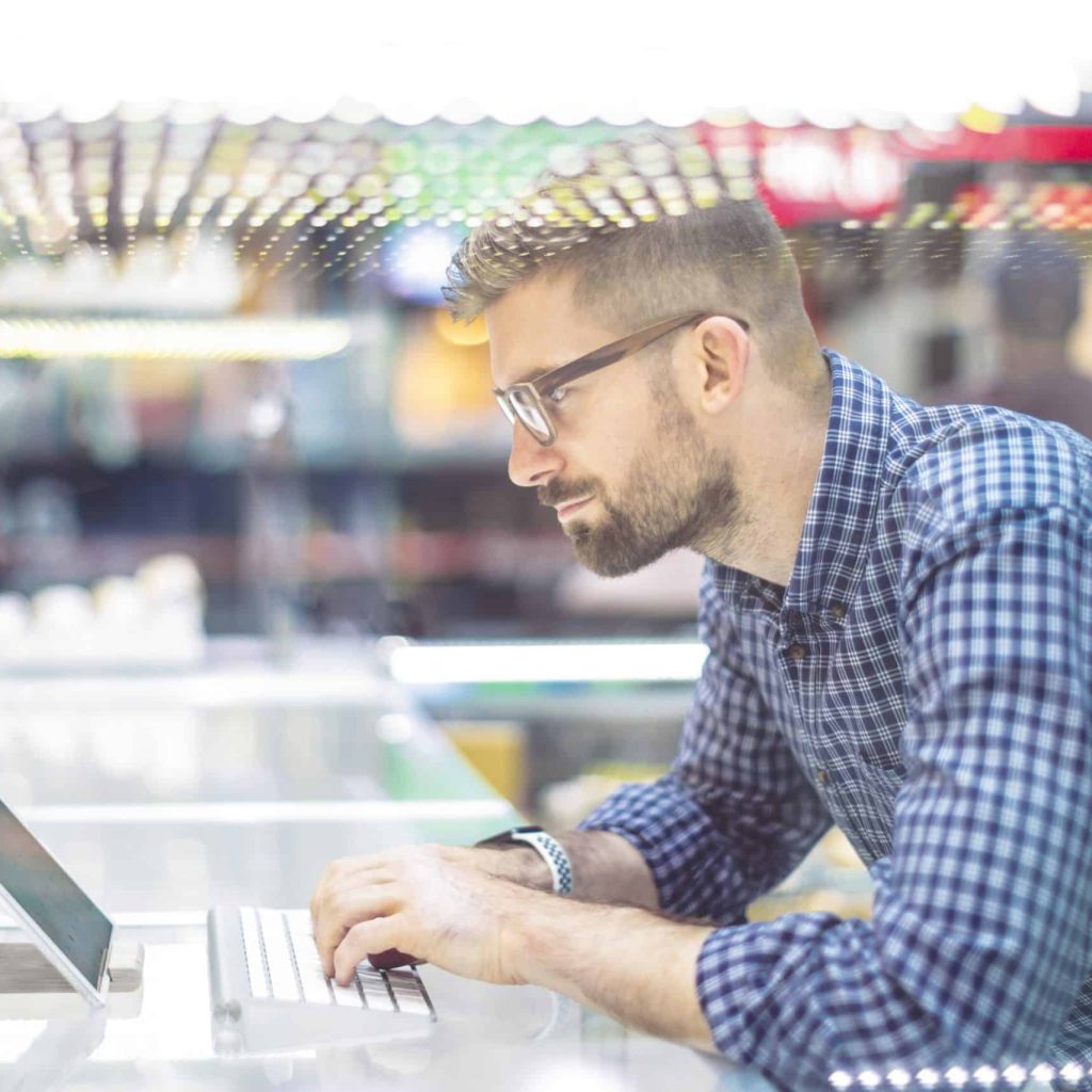 Young businessman is typing on his digital tablet