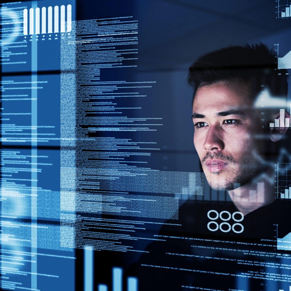 Shot of a focussed computer programmer working at his computer late at night