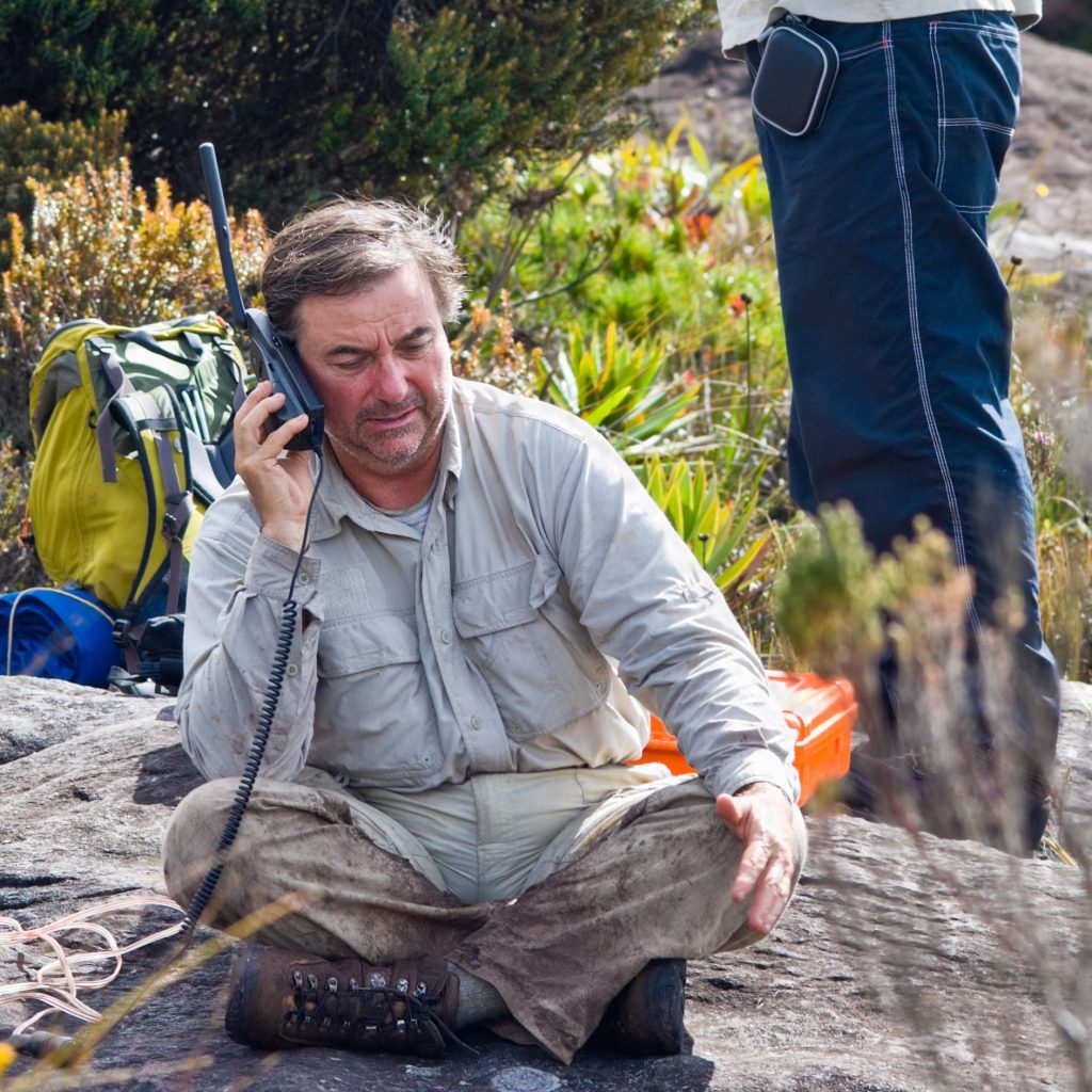 Expeditionary with a satellite portable phone at Auyan Tepuy, Venezuela