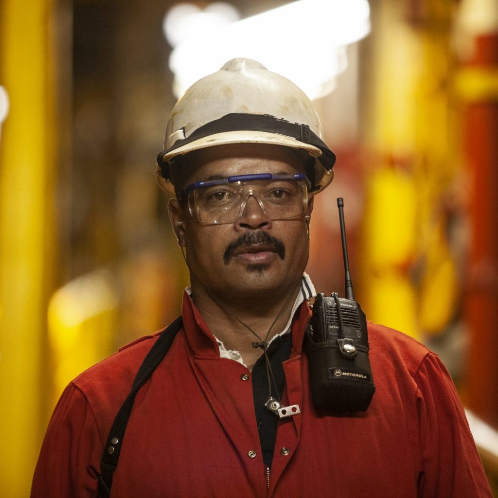 Roughneck on drilling rig Mossel Bay, Southern Cape, South Africa, December 13, 2007. A roughneck oil drilling worker with a cb radio on the rig, FA Platform, off the cost of Mossel Bay.