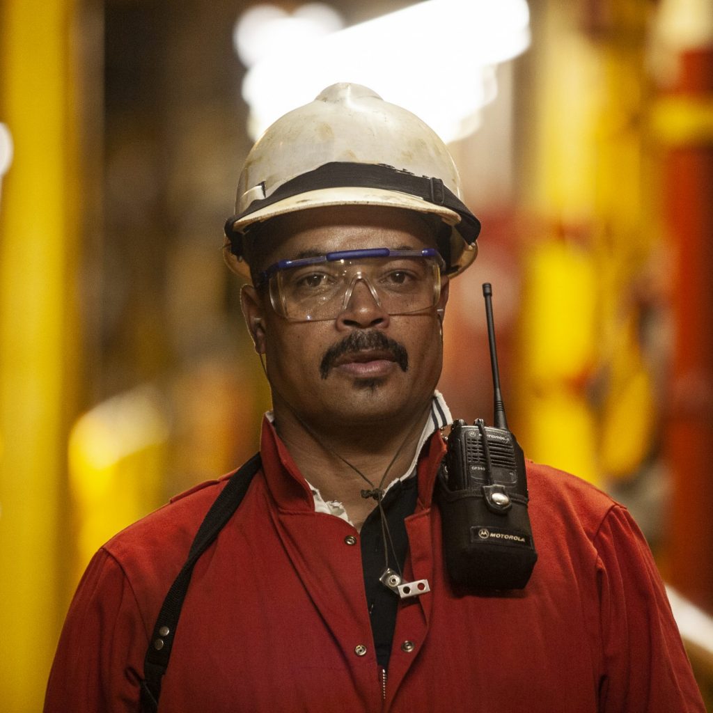 Mossel Bay, Southern Cape, South Africa, December 13,  2007.  A roughneck oil drilling worker with a cb radio on the rig, FA Platform,  off the cost of Mossel Bay.