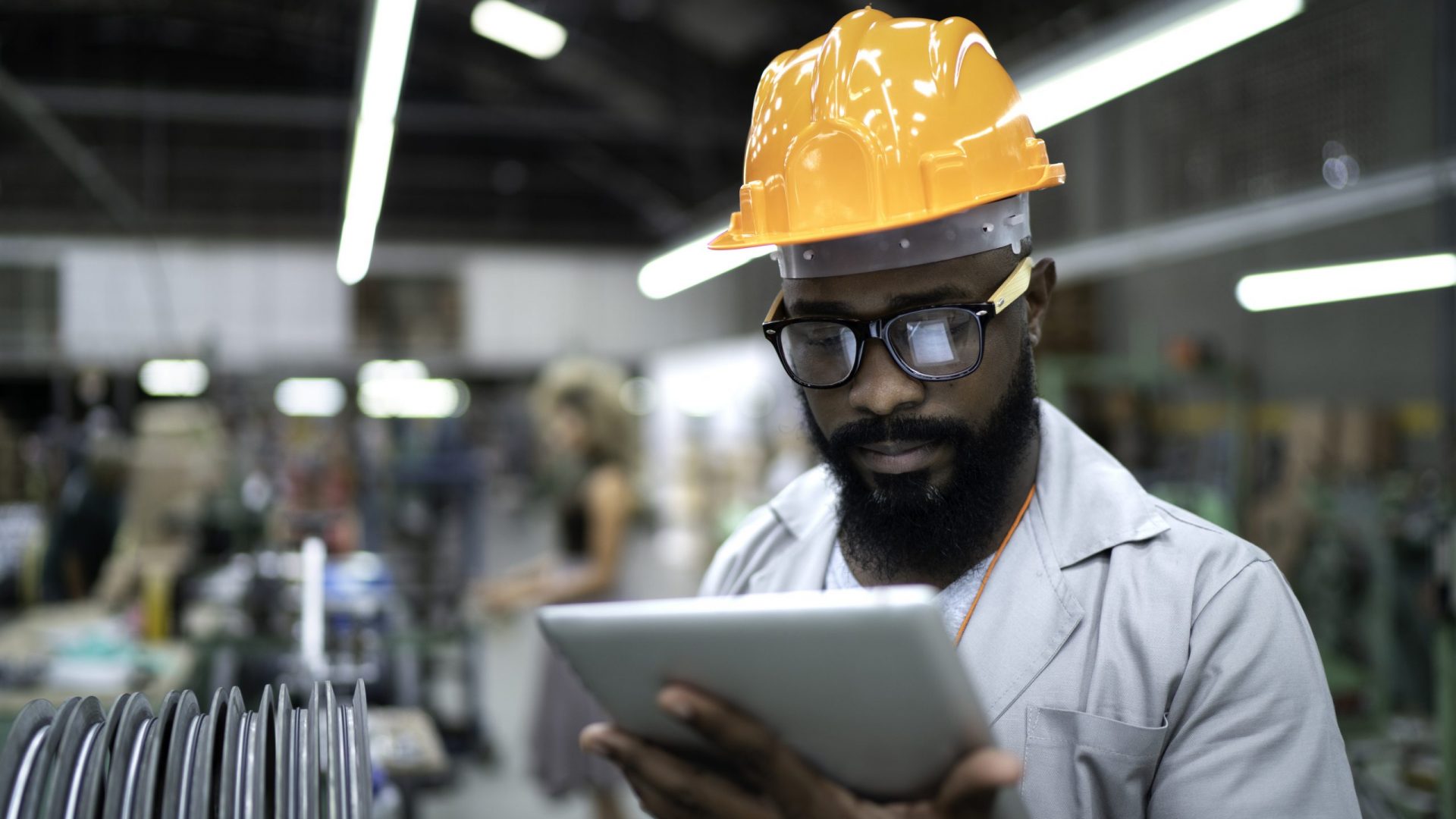 Engineer using tablet and working in factory