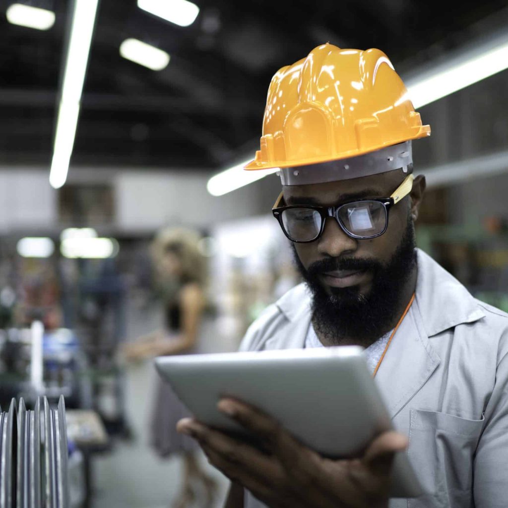 Engineer using tablet and working in factory